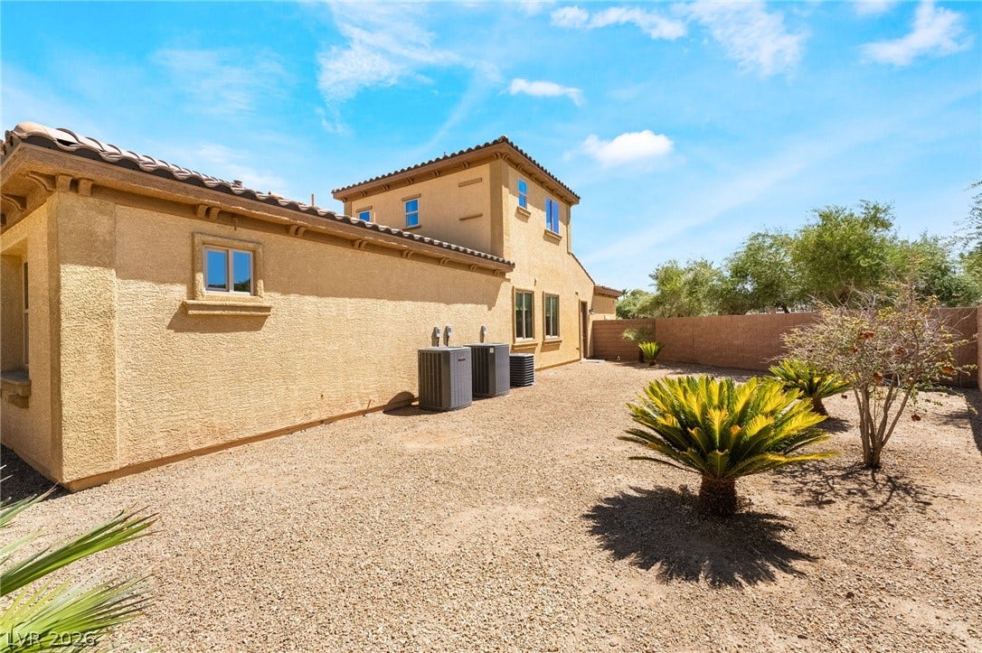 72 Rezzonico Drive, Henderson, NV 89011 Desert landscaping and stucco walls define this low-maintenance yard space.