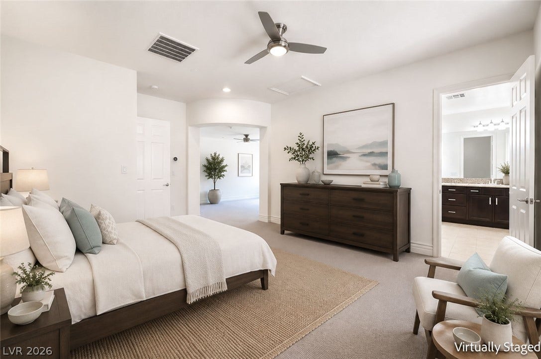 72 Rezzonico Drive, Henderson, NV 89011 Virtually staged. An arched doorway connects this spacious bedroom suite to an adjacent sitting area.