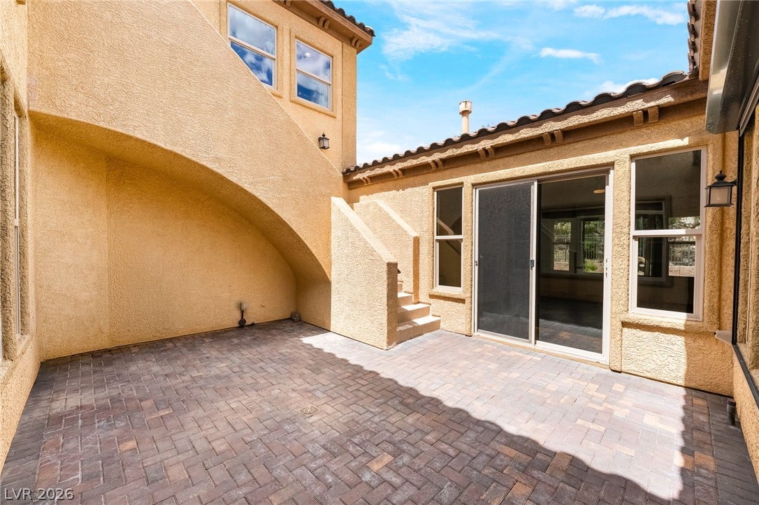 72 Rezzonico Drive, Henderson, NV 89011 A private stone paver patio offers an intimate outdoor retreat framed by stucco walls.