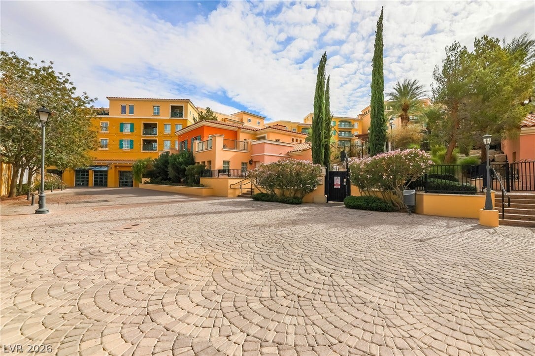 72 Rezzonico Drive, Henderson, NV 89011 An elegant cobblestone driveway sweeps toward beautifully designed Mediterranean-style multi-level residences.