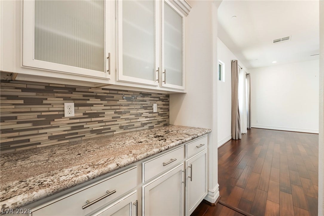 72 Rezzonico Drive, Henderson, NV 89011 Gleaming granite countertops and textured glass cabinetry create an elegant transitions to the living space.