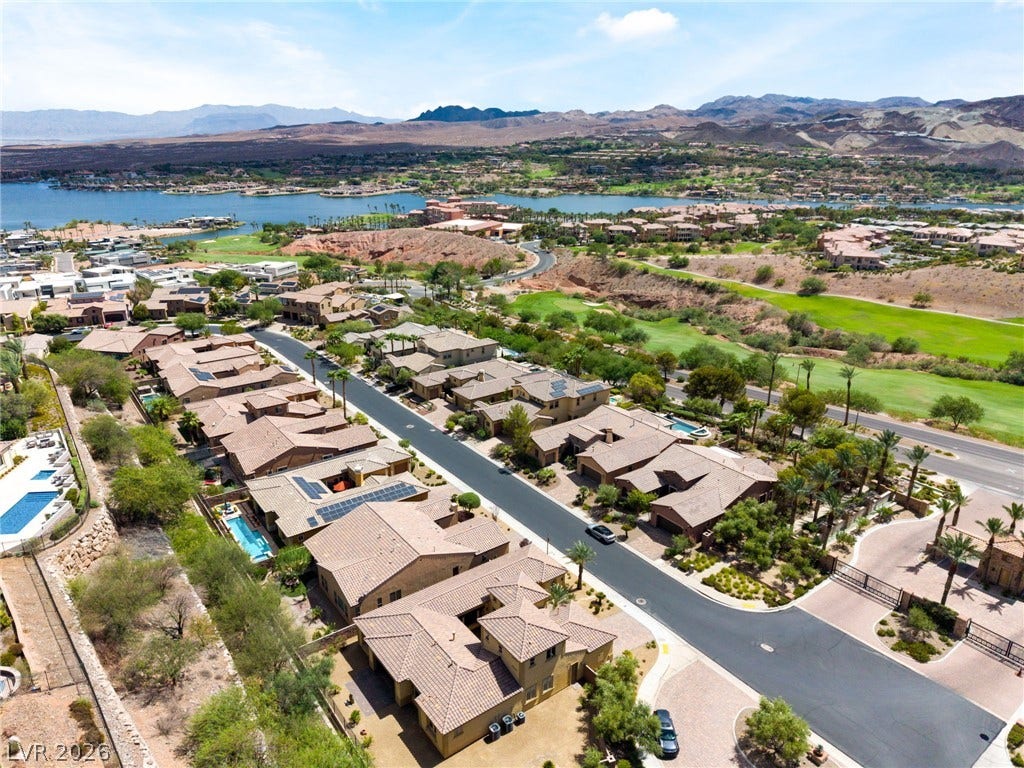 72 Rezzonico Drive, Henderson, NV 89011 Dramatic desert mountains and blue waters frame this peaceful neighborhood landscape.