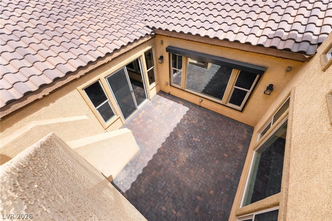 72 Rezzonico Drive, Henderson, NV 89011 An inviting paver courtyard nestled between stucco walls offers a private outdoor retreat.