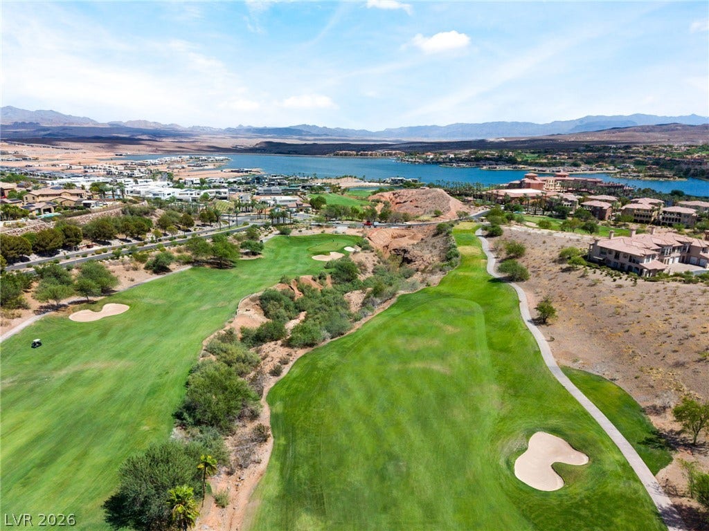 72 Rezzonico Drive, Henderson, NV 89011 Sweeping fairways and a shimmering lake define this vast desert landscape view.