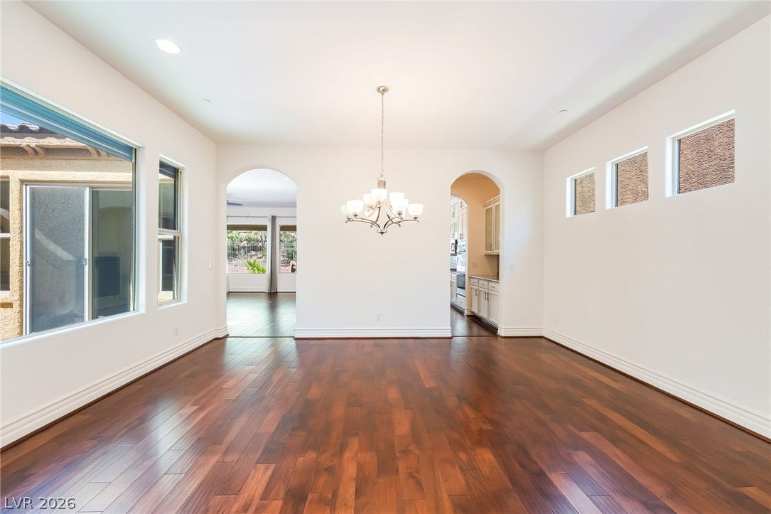 72 Rezzonico Drive, Henderson, NV 89011 Warm wood flooring pairs beautifully with graceful arched entries and classic crown molding details.