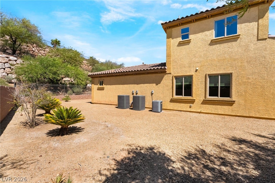 72 Rezzonico Drive, Henderson, NV 89011 Low-maintenance desert landscaping surrounds a stucco exterior with a durable tile roof.