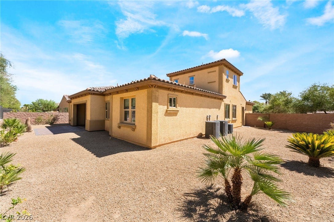 72 Rezzonico Drive, Henderson, NV 89011 Low-maintenance desert landscaping surrounds this multi-level home under a bright blue sky.