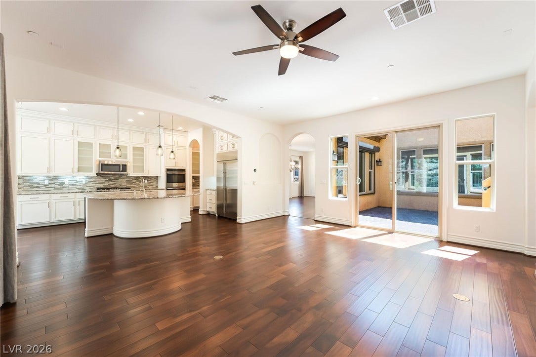 72 Rezzonico Drive, Henderson, NV 89011 Rich hardwood floors anchor this airy living space opening seamlessly into a bright modern kitchen.