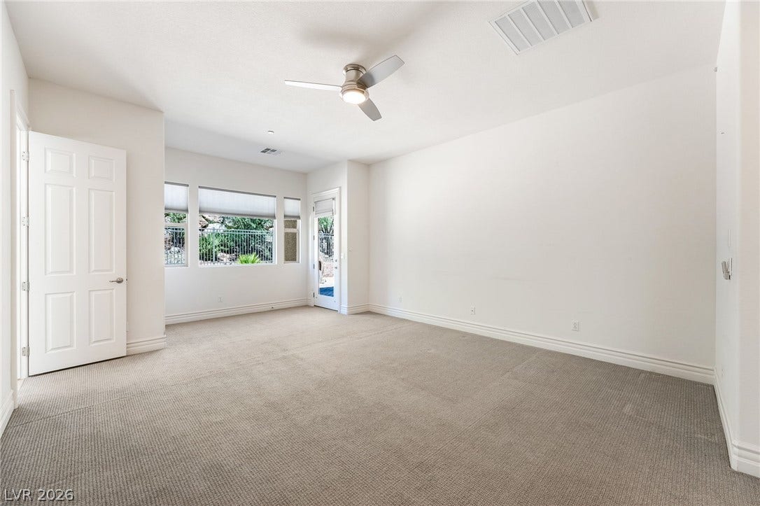 72 Rezzonico Drive, Henderson, NV 89011 Generous windows and soft carpeting define this versatile living space.