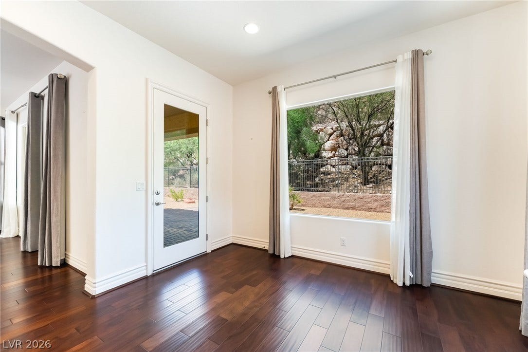 72 Rezzonico Drive, Henderson, NV 89011 Rich hardwood floors complement the natural light streaming through a large picture window.