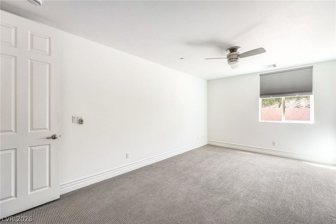 72 Rezzonico Drive, Henderson, NV 89011 A window overlooks the backyard in this comfortable bedroom with soft carpeting and clean baseboards.