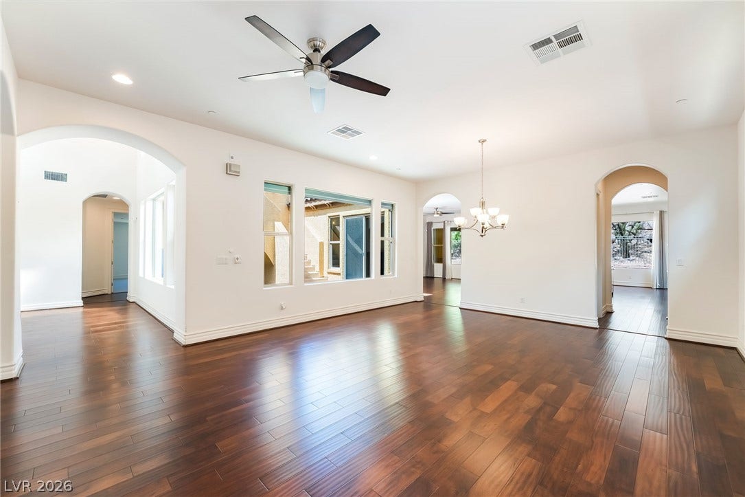 72 Rezzonico Drive, Henderson, NV 89011 Rich hardwood floors and elegant arched doorways ground this open, light-filled living space.