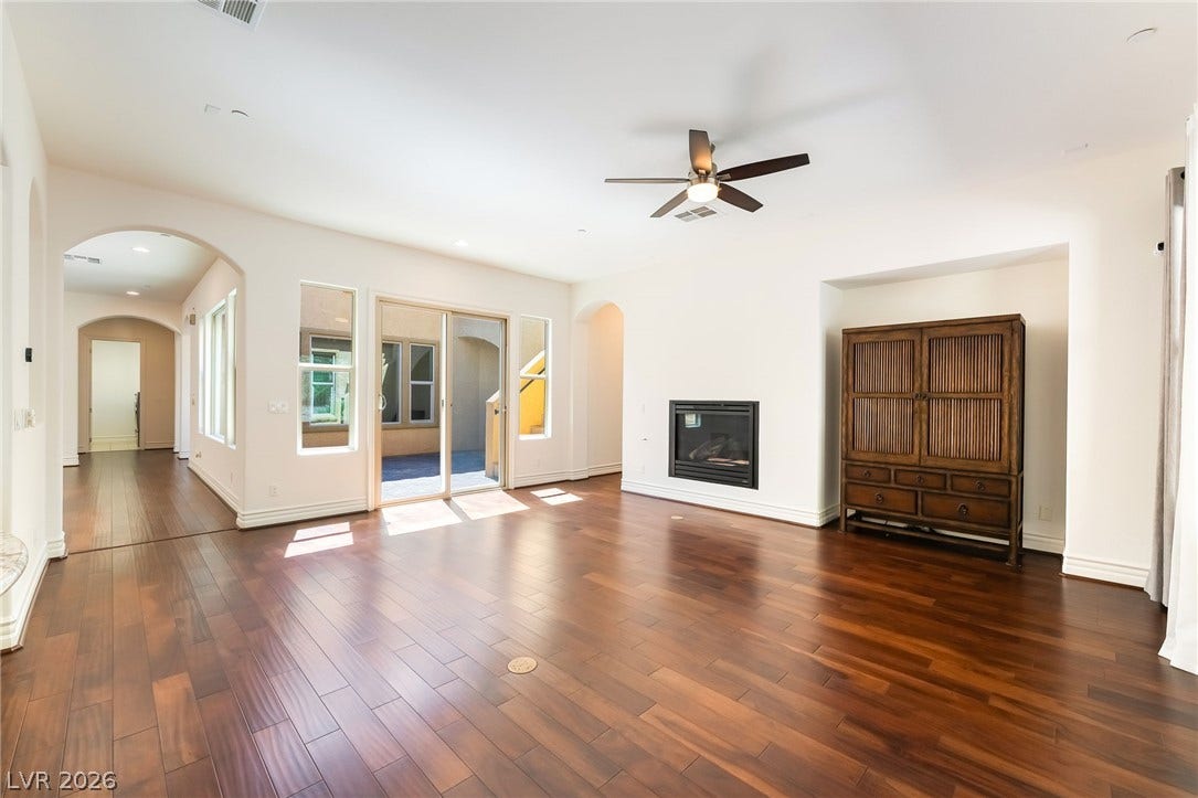72 Rezzonico Drive, Henderson, NV 89011 Rich hardwood flooring complements the smooth plaster walls and elegant arched passageways.