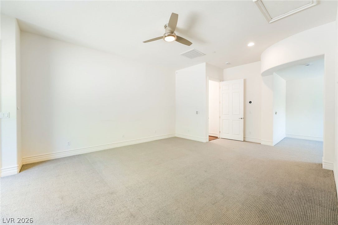 72 Rezzonico Drive, Henderson, NV 89011 Soft carpeting pairs with crisp baseboards in this versatile, neutral bedroom layout.