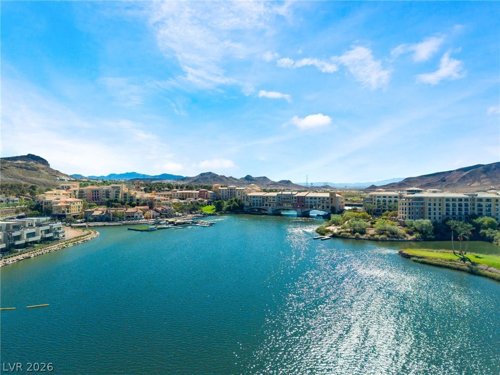 72 Rezzonico Drive, Henderson, NV 89011 Glistening waters stretch out toward a backdrop of desert mountains and waterside resort architecture.