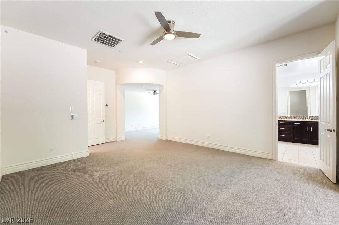72 Rezzonico Drive, Henderson, NV 89011 Plush carpeting and an open archway define this tranquil bedroom suite.