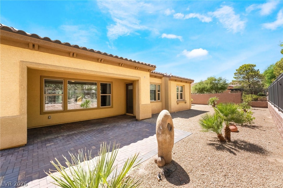 72 Rezzonico Drive, Henderson, NV 89011 An inviting covered patio opens to low-maintenance desert landscaping.