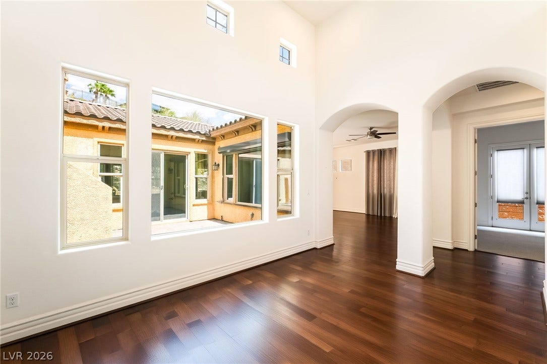 72 Rezzonico Drive, Henderson, NV 89011 Gleaming hardwood floors and high ceilings frame views of the private courtyard beyond.