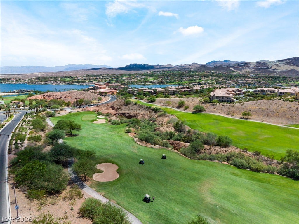 72 Rezzonico Drive, Henderson, NV 89011 Lush fairways wind through the desert landscape toward distant water and mountain views.