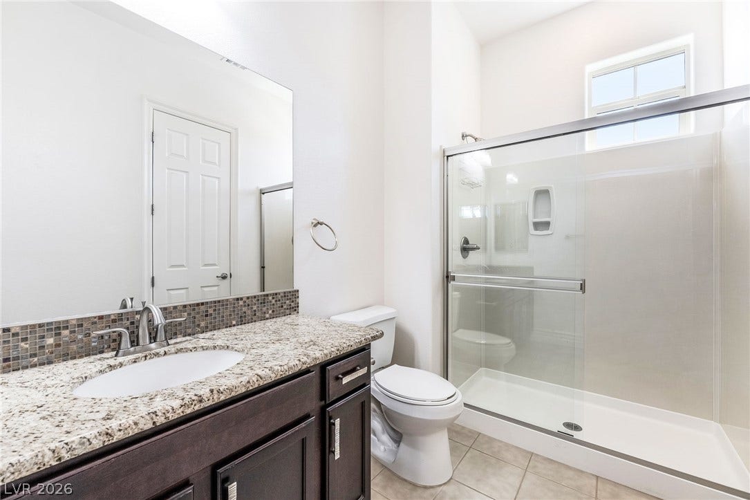 72 Rezzonico Drive, Henderson, NV 89011 Natural light illuminates a clean vanity counter and glass-enclosed walk-in shower.