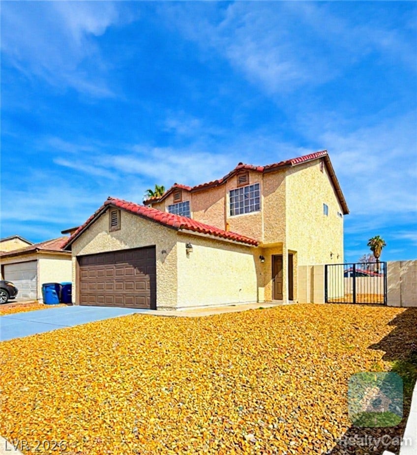601 Avon Avenue, Henderson, NV 89014 Textured stucco walls and a classic tile roof define this two-story residential facade.