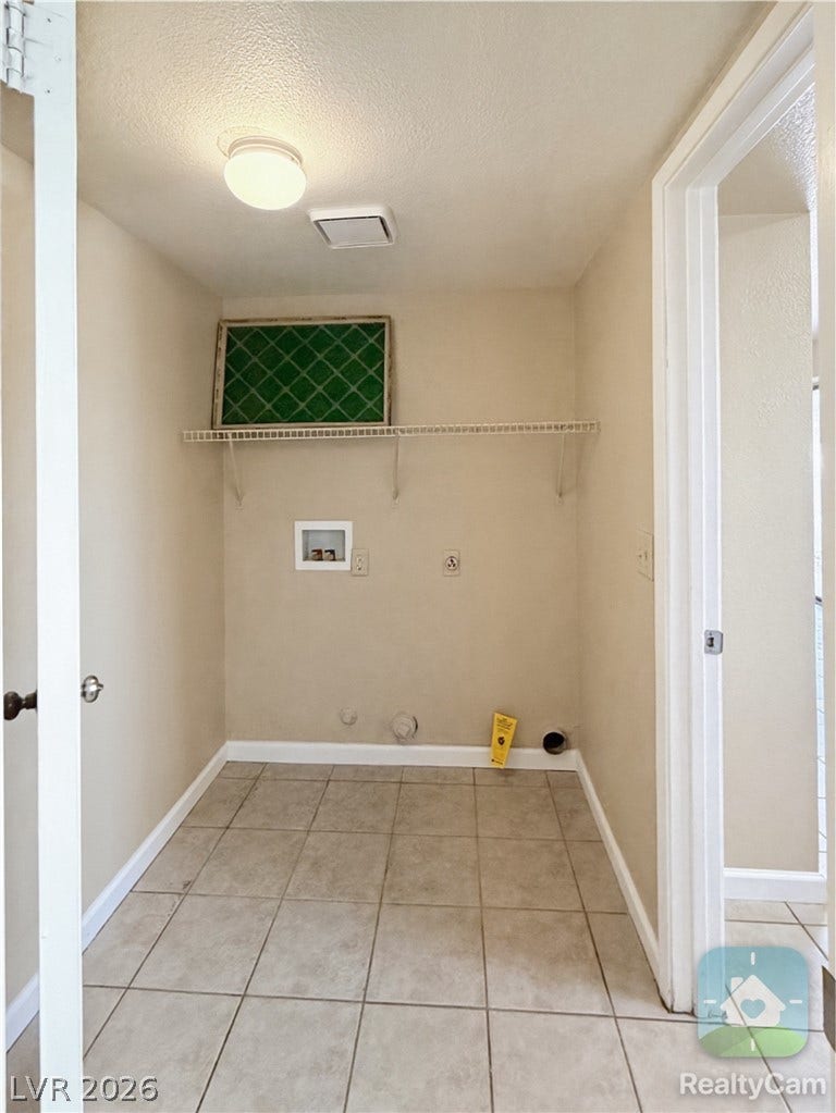 601 Avon Avenue, Henderson, NV 89014 Tiled flooring and overhead shelving maximize utility in this dedicated laundry space.