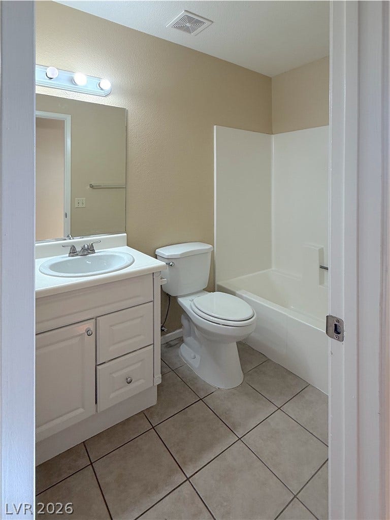 601 Avon Avenue, Henderson, NV 89014 Tiled flooring and a neutral color scheme define this functional bathroom layout.