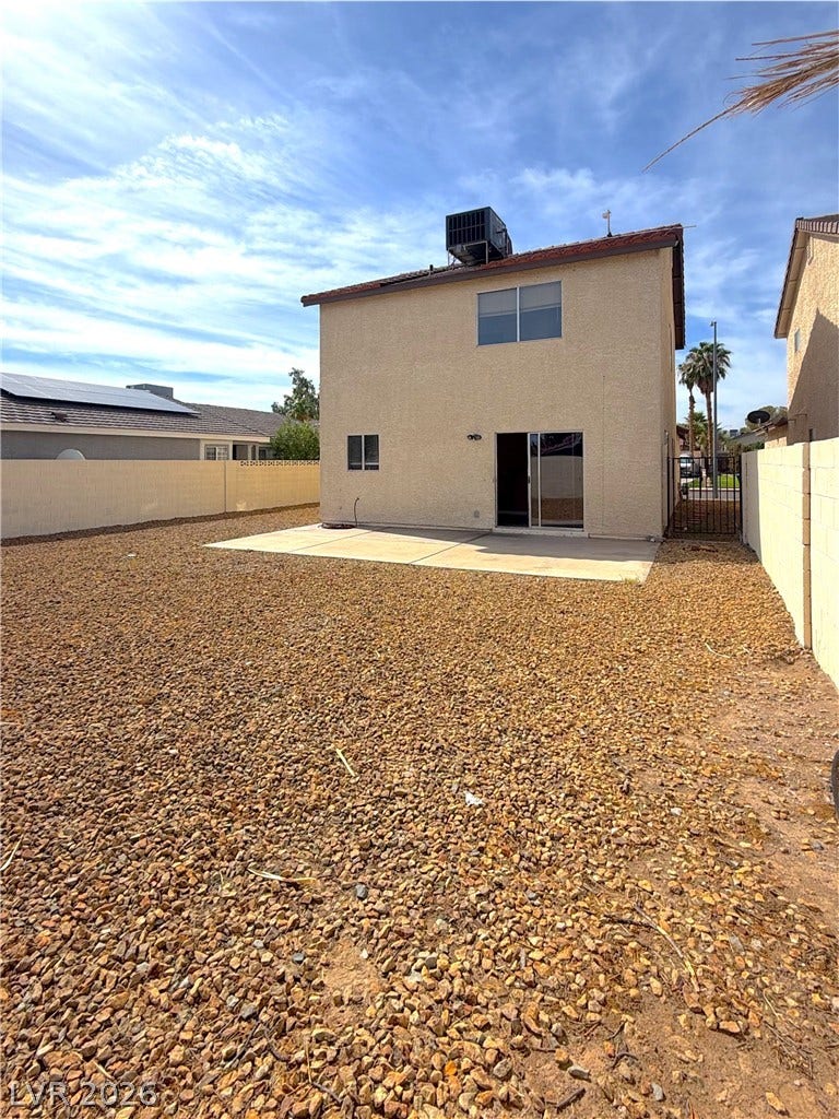 601 Avon Avenue, Henderson, NV 89014 A concrete patio overlooks a low-maintenance gravel yard enclosed by privacy walls.