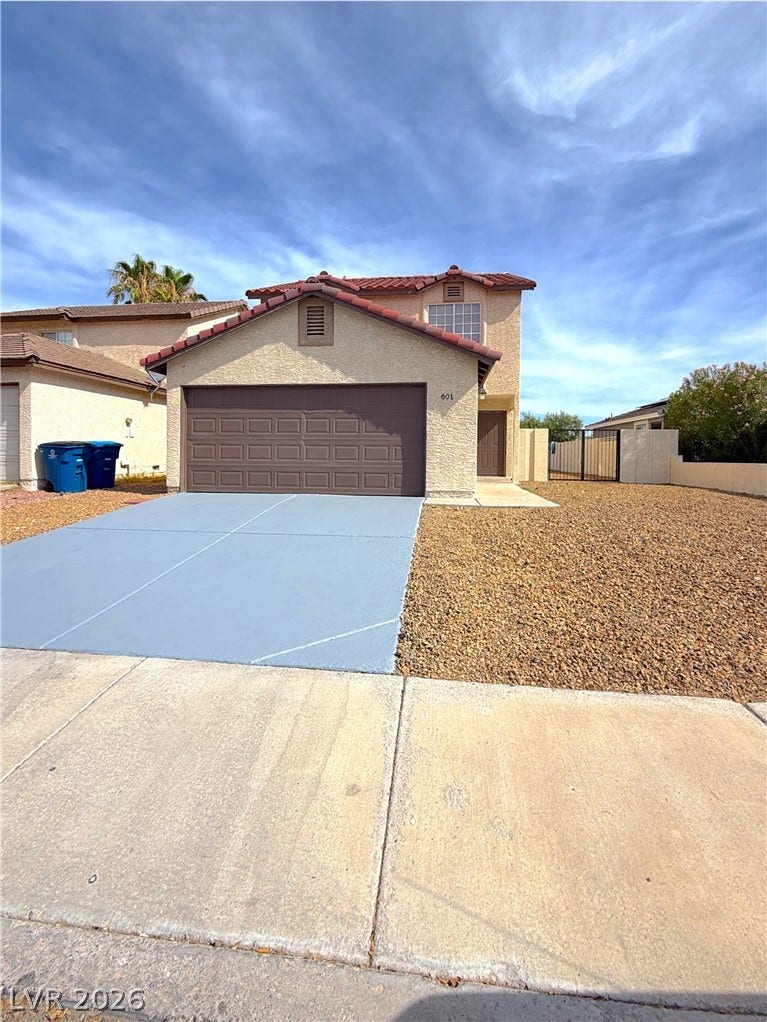 601 Avon Avenue, Henderson, NV 89014 Spanish tile roofing and textured stucco walls define this classic desert exterior with integrated garage.