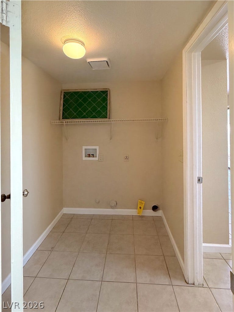 601 Avon Avenue, Henderson, NV 89014 Tiled flooring and built-in shelving define this functional space equipped with appliance connections.