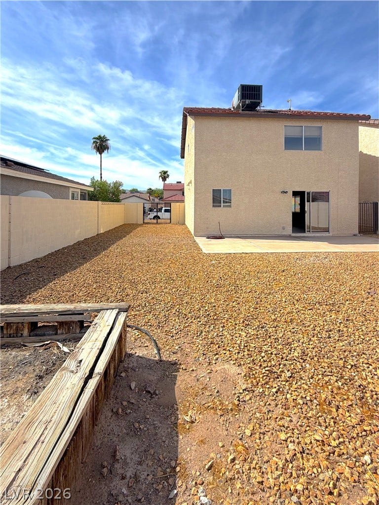 601 Avon Avenue, Henderson, NV 89014 Gravel landscaping fills the fenced yard adjacent to a concrete patio and stucco exterior.