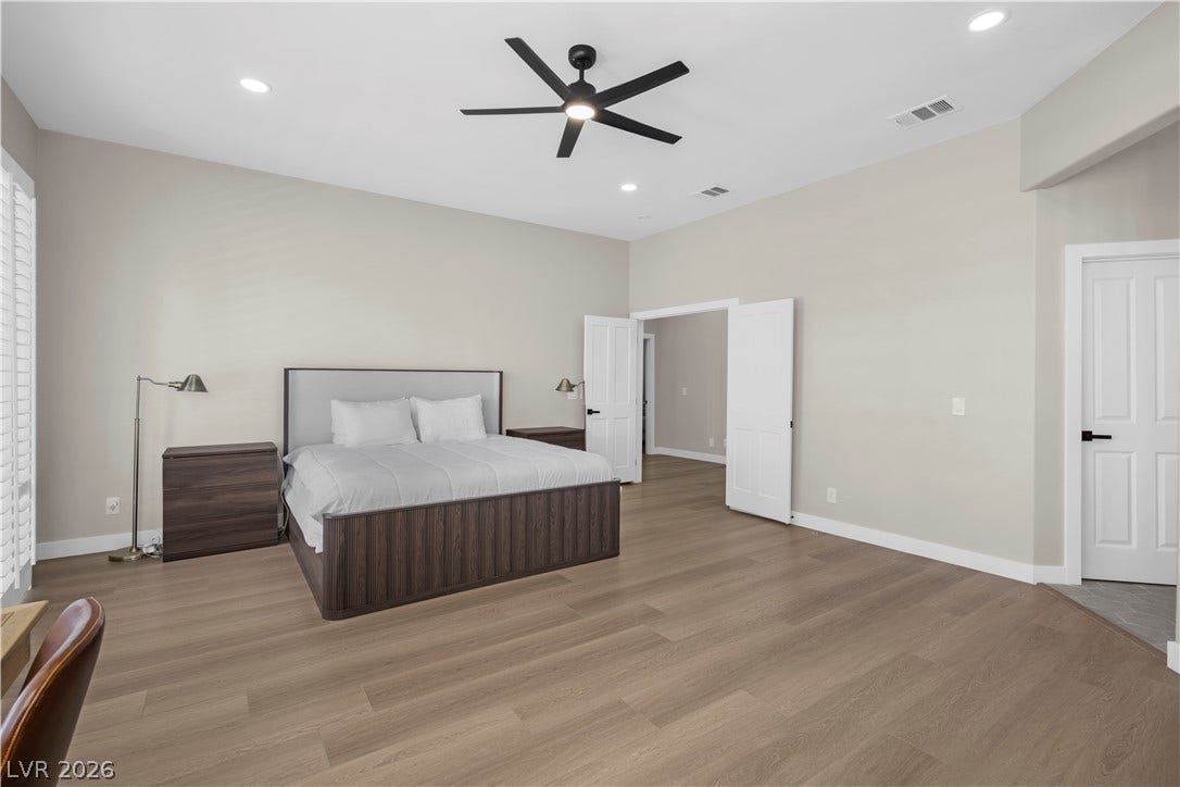 8848 Rainbow Ridge Drive, Las Vegas, NV 89117 High ceilings and clean wood-plank flooring define this spacious bedroom suite.