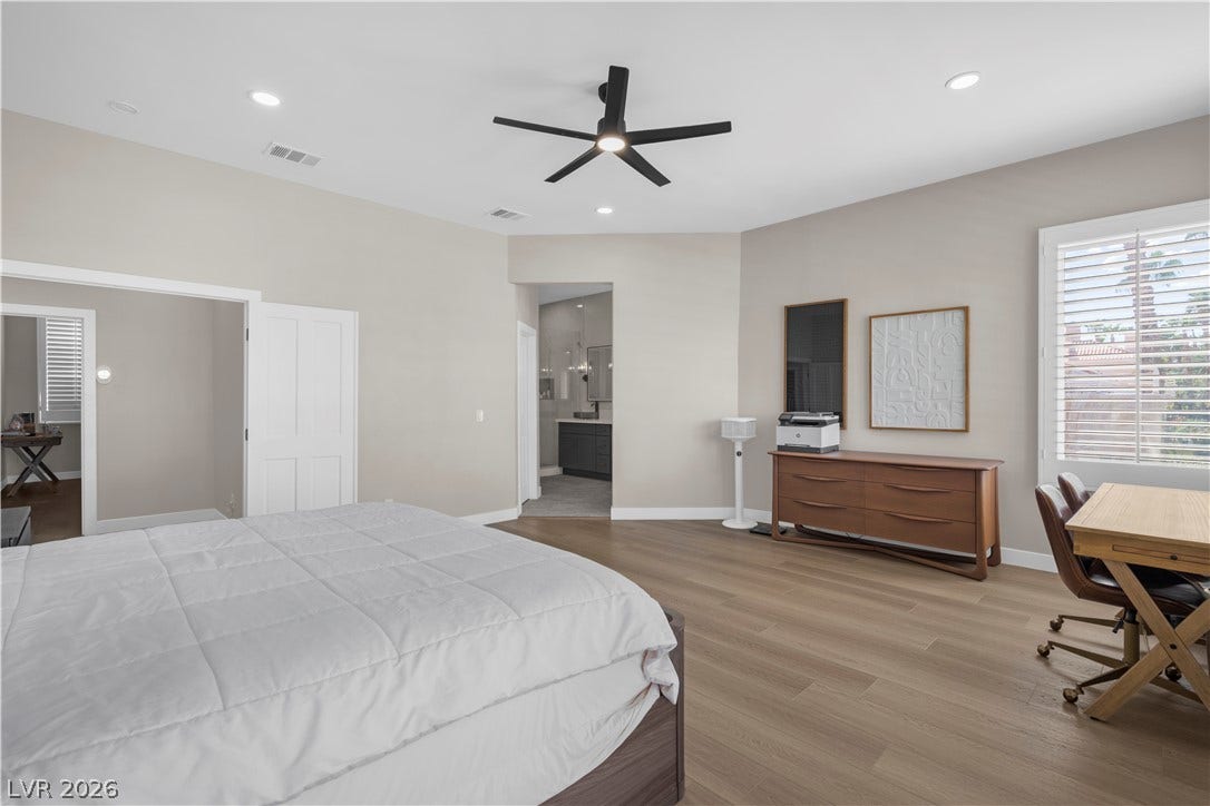 8848 Rainbow Ridge Drive, Las Vegas, NV 89117 Recessed lighting and warm wood flooring define this comfortable bedroom suite.