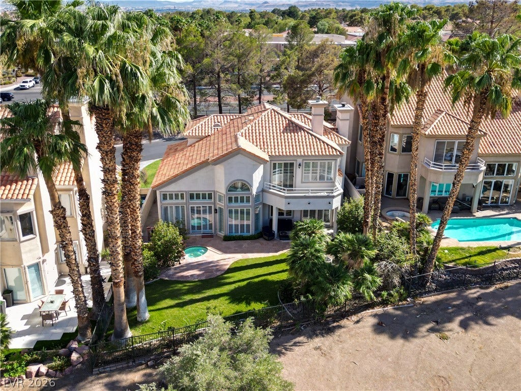8848 Rainbow Ridge Drive, Las Vegas, NV 89117 Spanish tile roofs and soaring palm trees frame this elegant multi-level residence with private outdoor space.