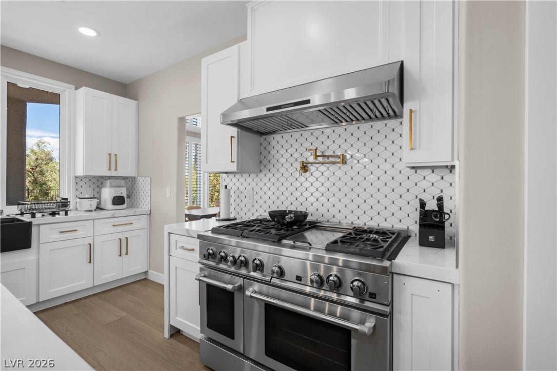 8848 Rainbow Ridge Drive, Las Vegas, NV 89117 Timeless wood flooring and shaker cabinetry create a classic culinary space.