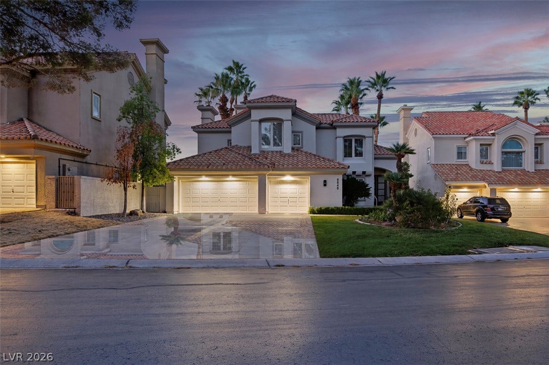 8848 Rainbow Ridge Drive, Las Vegas, NV 89117 Clay tile roofing and stucco siding define this multi-level suburban residence with a paver driveway.