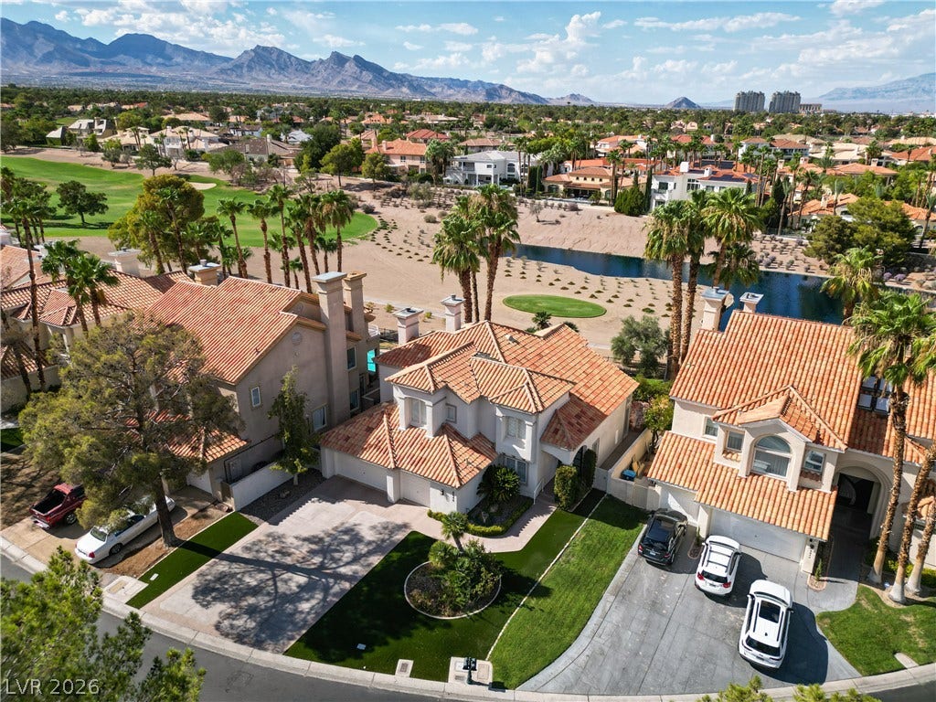 8848 Rainbow Ridge Drive, Las Vegas, NV 89117 A striking tile roof anchors this elegant home bordering a scenic golf course and mountain backdrop.