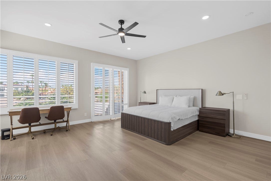 8848 Rainbow Ridge Drive, Las Vegas, NV 89117 Rich wood floors and recessed lighting enhance this expansive primary suite.