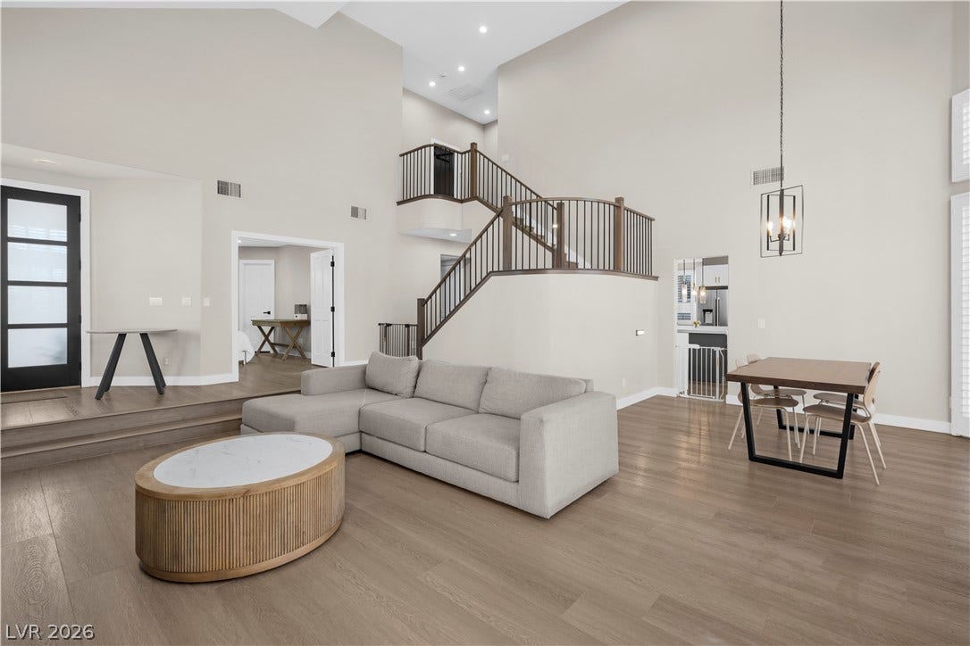 8848 Rainbow Ridge Drive, Las Vegas, NV 89117 Soaring ceilings and rich wood floors anchor this expansive open concept living area.