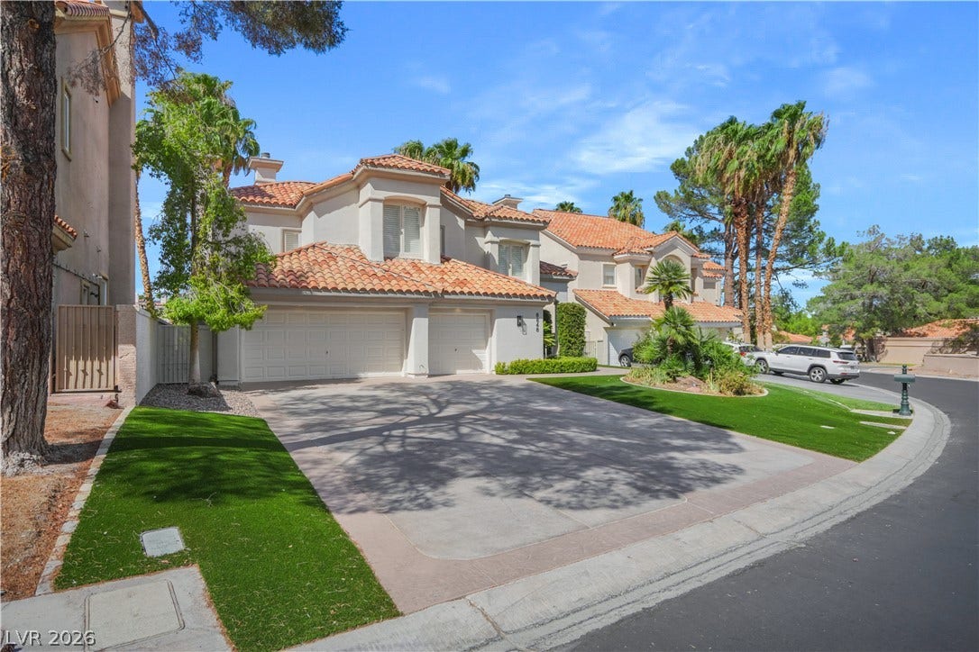 8848 Rainbow Ridge Drive, Las Vegas, NV 89117 Spanish tile roofing and a concrete driveway define this multi-level suburban residence.