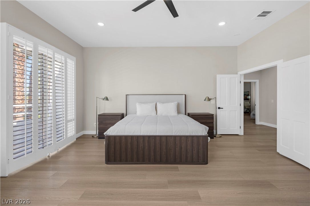 8848 Rainbow Ridge Drive, Las Vegas, NV 89117 Smooth wood floors and recessed lighting enhance this spacious bedroom complete with plantation shutters.