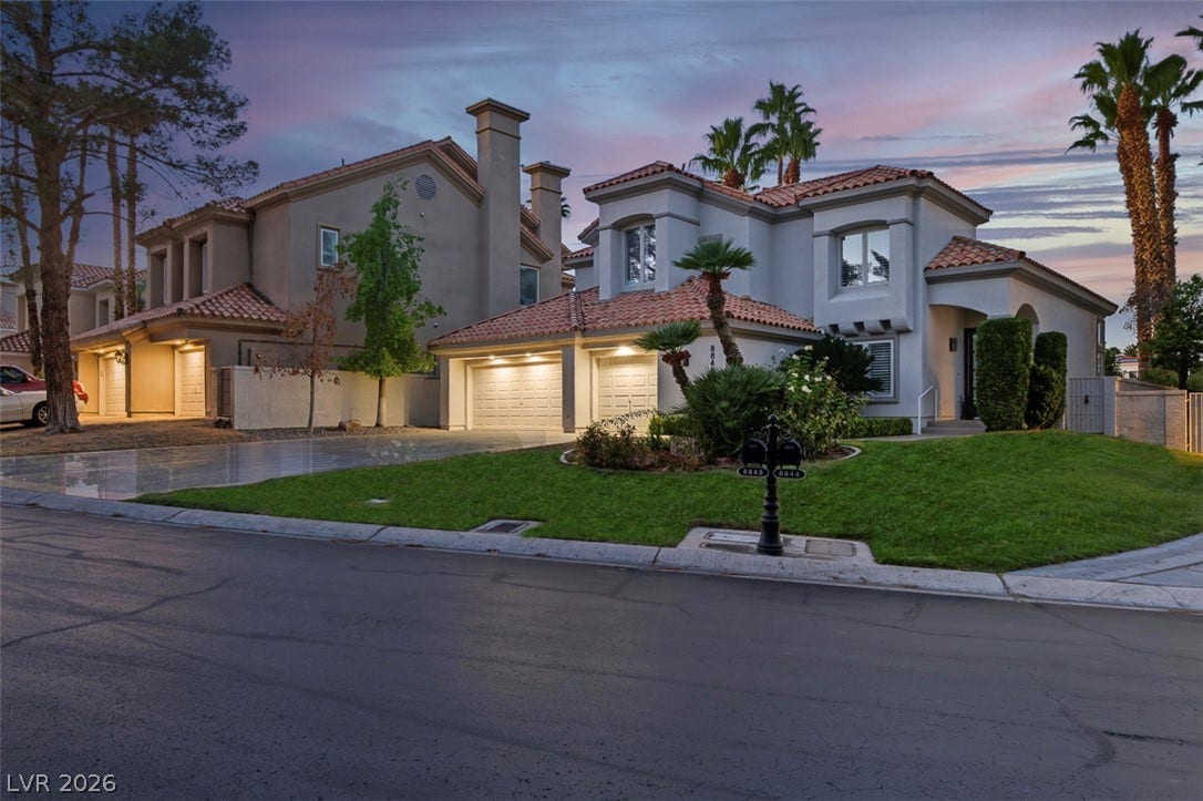 8848 Rainbow Ridge Drive, Las Vegas, NV 89117 A classic stucco exterior is paired with Spanish tile roofing on this multi-level suburban home.