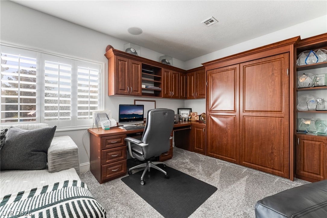 826 Rising Star Drive, Henderson, NV 89014 Rich wood built-ins and custom cabinetry elevate this functional home workspace.