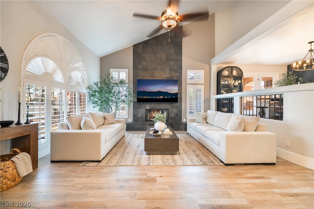 826 Rising Star Drive, Henderson, NV 89014 A soaring vaulted ceiling and a floor-to-ceiling tiled fireplace anchor this open living area.
