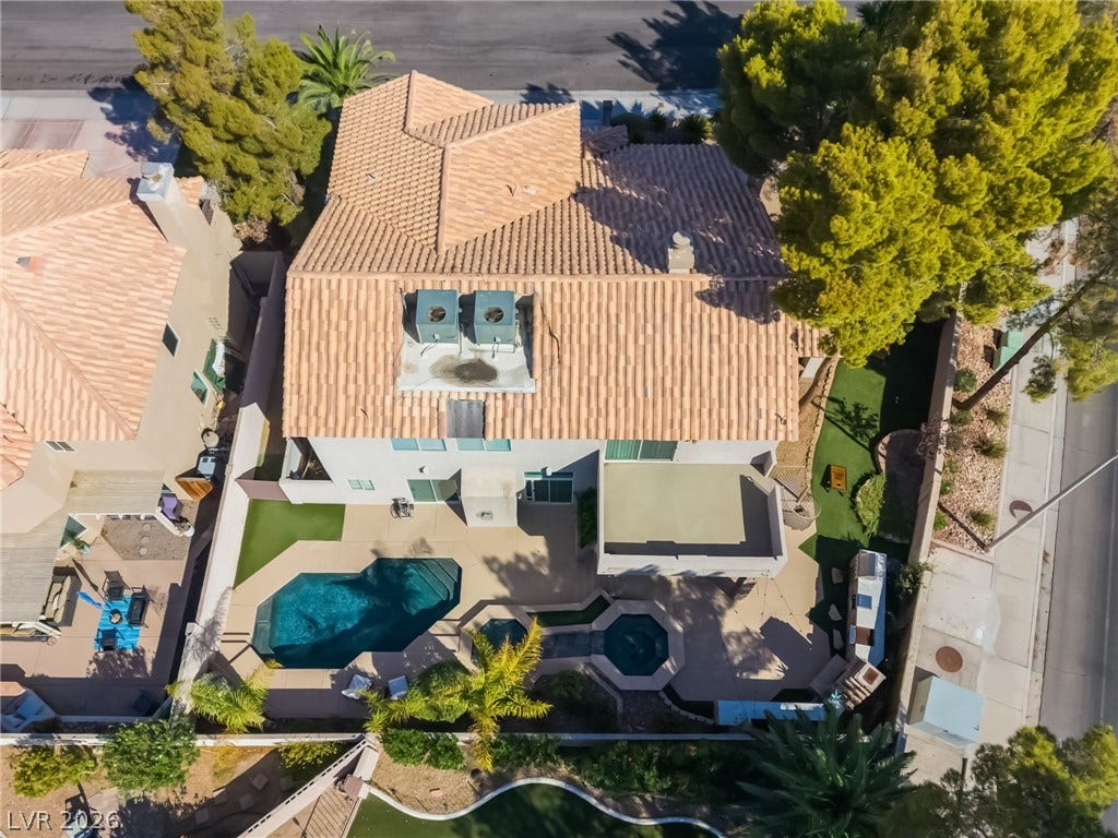 826 Rising Star Drive, Henderson, NV 89014 An aerial perspective showcases a tiled roof, private swimming pool, and manicured backyard landscaping.