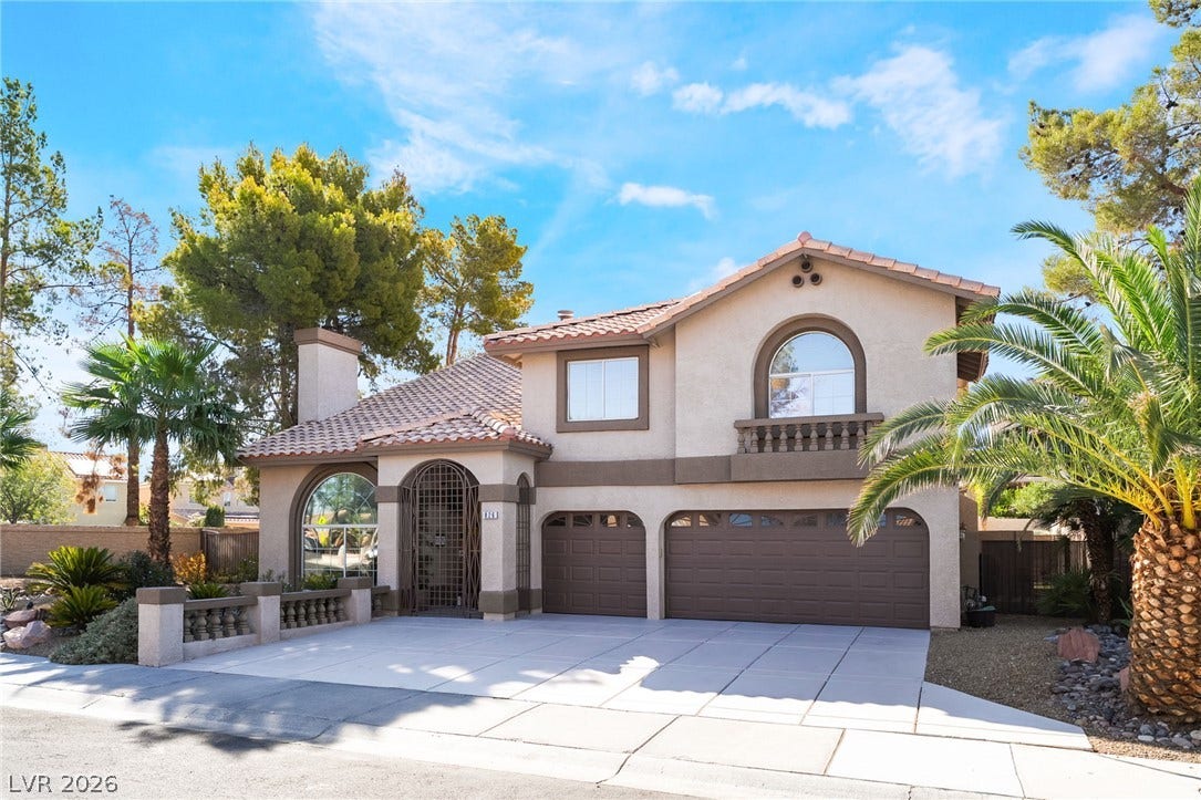 826 Rising Star Drive, Henderson, NV 89014 Spanish-style architecture highlights this multi-level exterior featuring a tile roof and arched window accents.