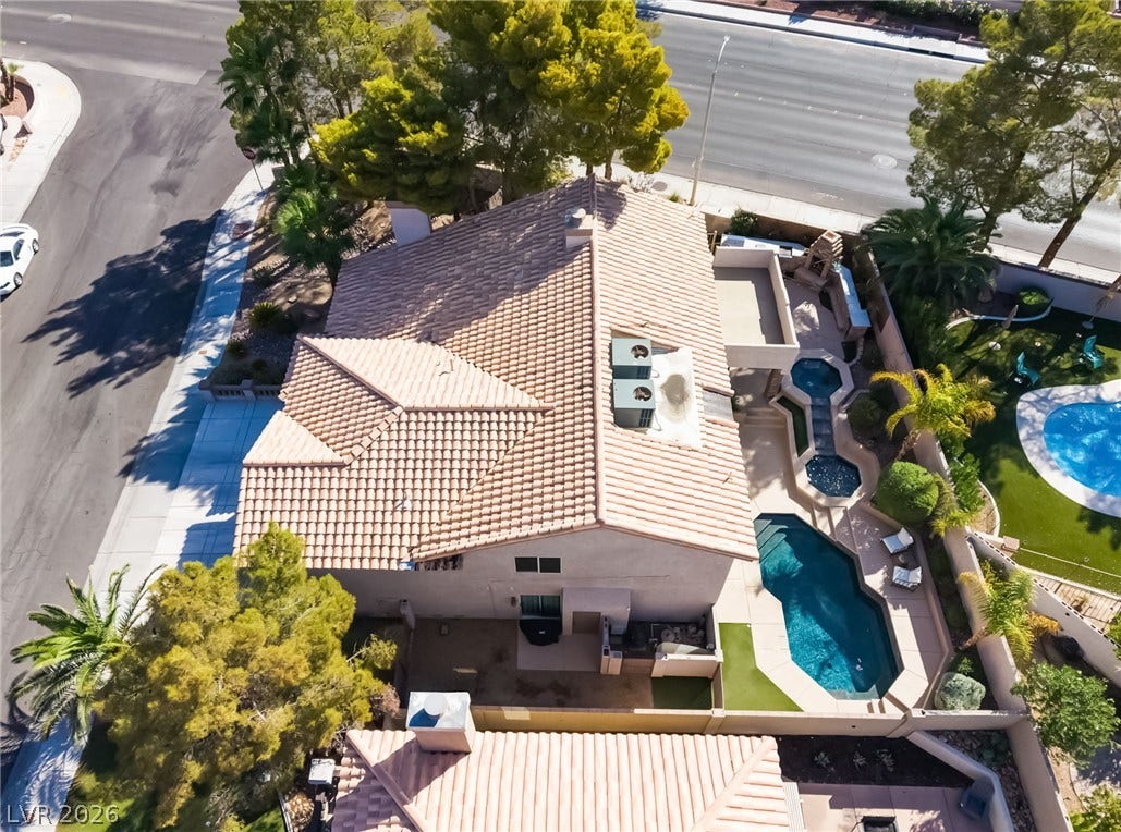 826 Rising Star Drive, Henderson, NV 89014 Spanish tile roofing and a private backyard pool highlight this aerial view.