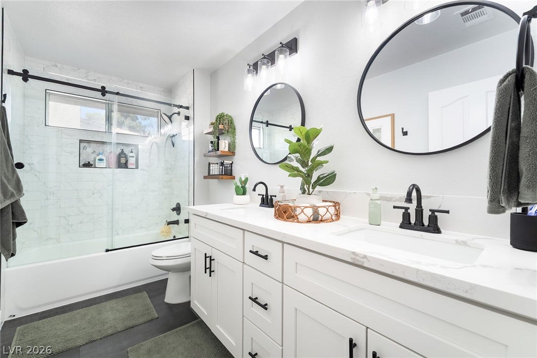 826 Rising Star Drive, Henderson, NV 89014 Clean lines and stone counters highlight this updated vanity alongside a glass-enclosed shower.