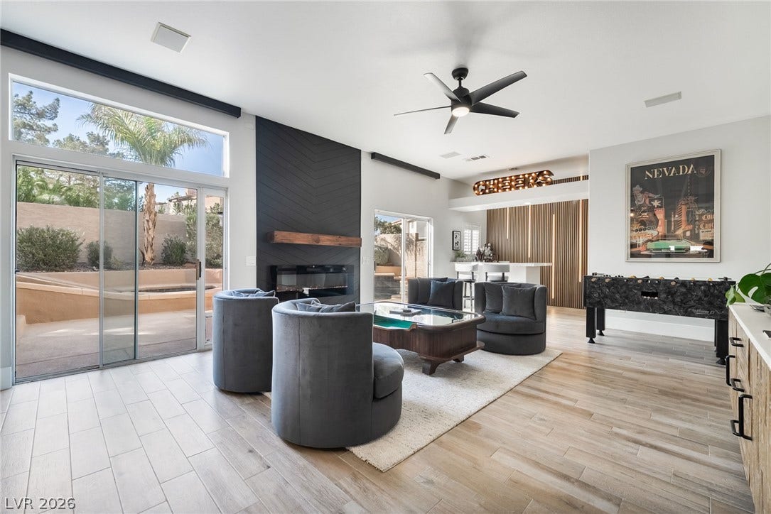 826 Rising Star Drive, Henderson, NV 89014 Sliding glass doors open to the outdoors from this modern living space with wood-look tile floors.