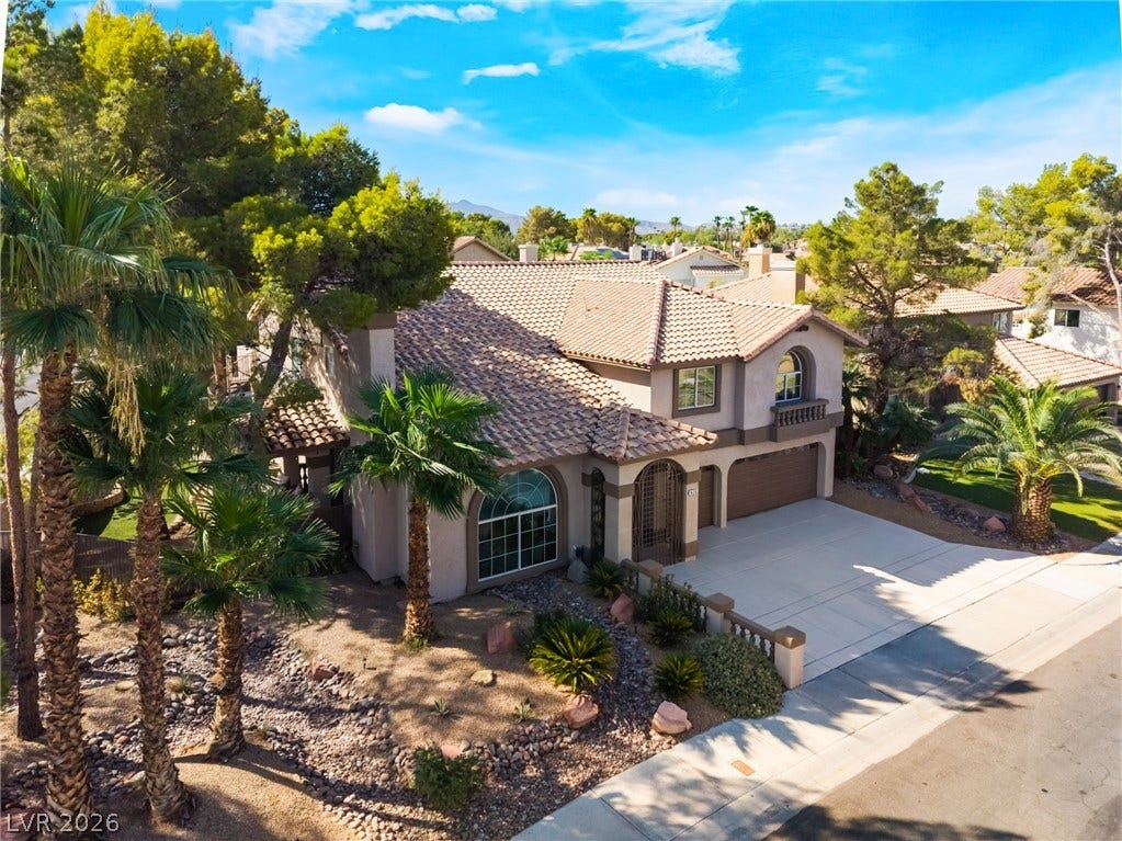 826 Rising Star Drive, Henderson, NV 89014 Spanish tile roofing and custom masonry details accent this striking two-story desert residence.